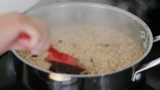 Frame at second 8: red spatula stirring the pot